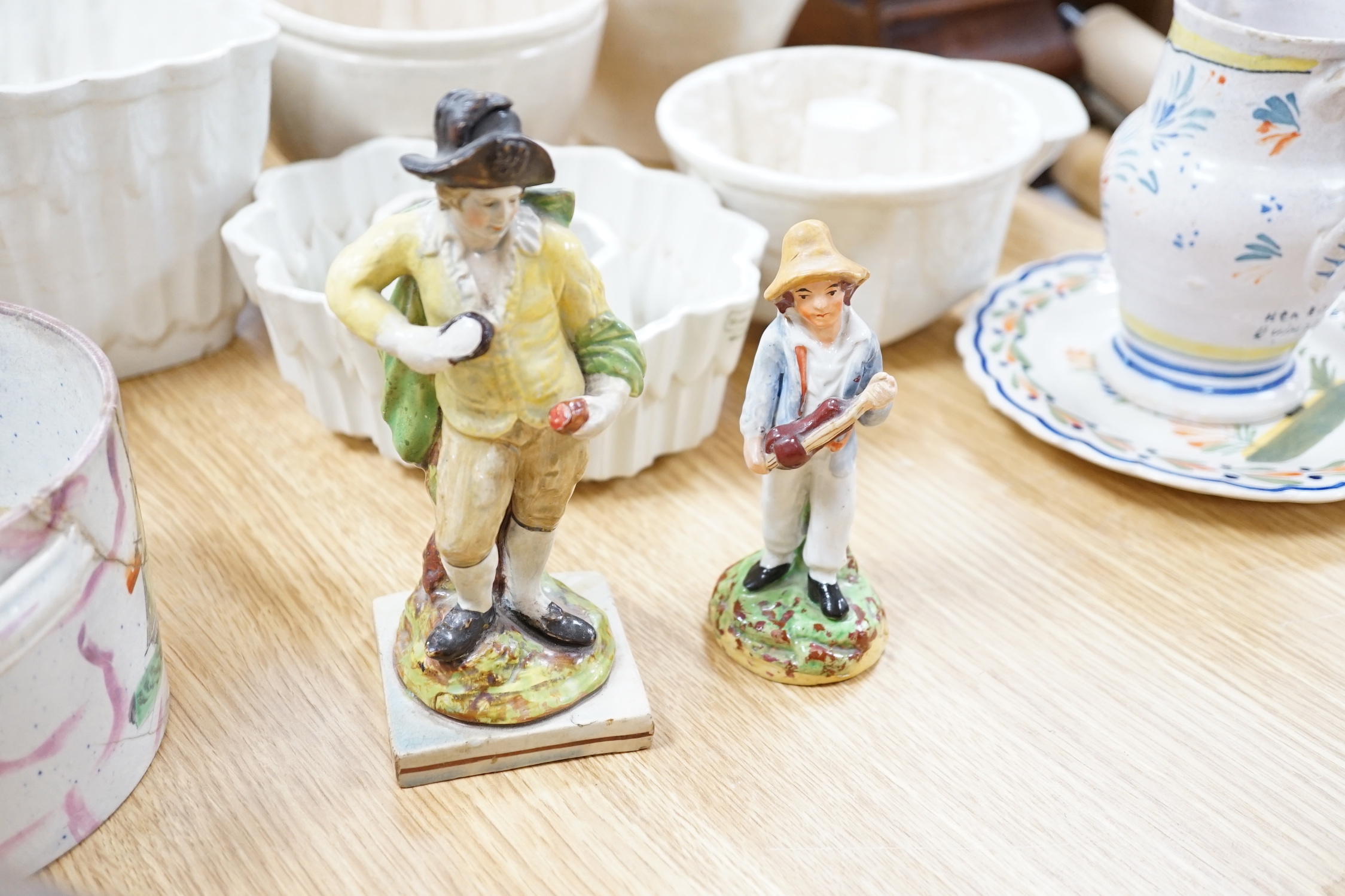 Large collection of mostly 19th century ceramics including Staffordshire figures, jugs, jelly moulds and a twin handled cup, the largest 24cm high